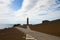 Lighthouse Capelinhos on the shore of Atlantic ocean, island Faial, Azores