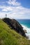 Lighthouse on a cliff by the sea. Vertical picture. Cape Byron. Byron Bay, New South Wales NSW, Australia