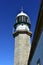 Lighthouse closeup. Sunny day, blue sky. Galicia, Spain.