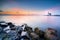 Lighthouse on the Dutch coast near the island of `marken` during sunrise on a large inland lake