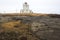 Lighthouse Dyrholaey and Reynisdrangar rocks on the background, Iceland