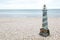 Lighthouse figure on the beach in the evening