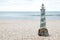 Lighthouse figure on the beach in the evening