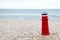 lighthouse figure on the beach in the evening