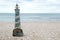 Lighthouse figure on the beach in the evening