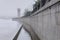 Lighthouse on the flooded embankment in the early summer morning.