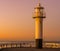 The lighthouse on the harbor pier of Blankenberge, Belgium, popular architecture at sunset