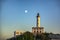 Lighthouse on a hilltop at sunset