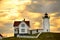 The lighthouse and the house of the keeper of the lighthouse on the hill against the sunset sky. Atlantic Ocean. USA. Maine. Nubbl