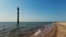 Lighthouse inside the water, sea. Lighthouse along the shoreline, leaning inside