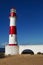 Lighthouse Itapua beach with blue sky, Salvador, Bahia, Brazil