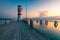 Lighthouse at Lake Neusiedl, Podersdorf am See, Burgenland, Austria. Lighthouse at sunset in Austria. Wooden pier with lighthouse