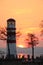 Lighthouse on a lake at sundown