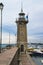 Lighthouse and lanterns, boats on the dock on the Garda. Italy