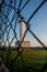 Lighthouse of Lastres with the fence on the foreground captured in the town of Luces, Spain