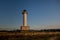 Lighthouse of Lastres with the fence on the foreground captured in the town of Luces, Spain