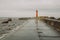 Lighthouse in Latvia, Riga. Travel photo. Mole and sea.
