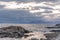 Lighthouse on the Lofoten Islands. Travel to Norway. Norwegian fjords. Huge blocks of stones in the foreground. Photo taken at