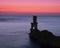 Lighthouse for maritime navigation at sunset,