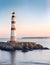 Lighthouse in the morning sea shore, beacon building at scenery nature ocean landscape. Nautical seafarer on rocky coast. Marine