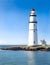 Lighthouse in the morning sea shore, beacon building at scenery nature ocean landscape. Nautical seafarer on rocky coast under