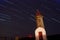 Lighthouse at night with startrails