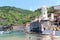 Lighthouse and olive terraces in Cinque Terre village Vernazza