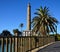 Lighthouse, palm tree and blue sky