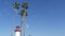 Lighthouse, palm trees and blue sky. Red and white beacon. Waterfront harbor village. California USA