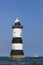 The lighthouse at Penmon Point Anglesey with motor boat