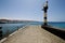 Lighthouse and pier boat in the blue sky arrecife