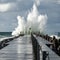 Lighthouse on the pier of Norre Vorupor during storm and heavy sea, Jutland, Denmark