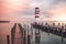 Lighthouse with a Pier at Sunrise