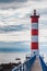 Lighthouse of Port-La-Nouvelle in red and white on cloudy sky