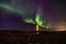 Lighthouse on Reykjanes peninsula under nortern lights. Iceland