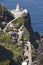 Lighthouse, road and atlantic ocean in Ponta do Arnel, Azores