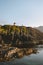 Lighthouse on rocks in sea and traveler minimal landscape