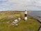 Lighthouse, rocky beach and farms  in Inisheer island