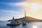 Lighthouse and sailboat docked in the port of the city of Ibiza, Bareares Islands.