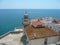 Lighthouse with the sea in the background and white houses with tiled roofs in the foreground, PeÃ±Ã­scola, CastellÃ³n, Spain