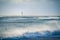 Lighthouse in the sea during windstorm with seagulls flight