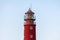 Lighthouse in seaport. Beautiful russian Baltiysk beacon. Scenery blue sky, copy space