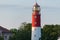 Lighthouse in seaport. Beautiful russian Baltiysk beacon. Scenery blue sky, copy space