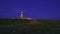 Lighthouse sending its light beam at night, cape Espichel, Portugal