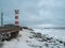 Lighthouse on the shore of the raging White sea on the Kola Peninsula