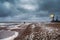 Lighthouse on the shore of the raging White sea on the Kola Peninsula. Kandalaksha bay