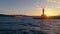 Lighthouse silhouette and sea at sunset in Varna