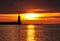 Lighthouse silhouette during sunrise over the baltic sea in gdynia, poland