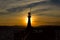 Lighthouse silhouette at sunset