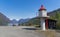 A lighthouse with small boat on the coast of Fjord in Flam